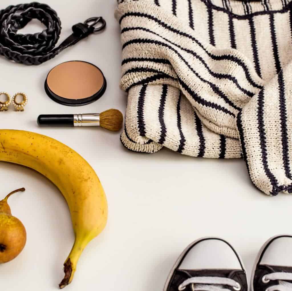 Clothing and fashion accessories laid out flat