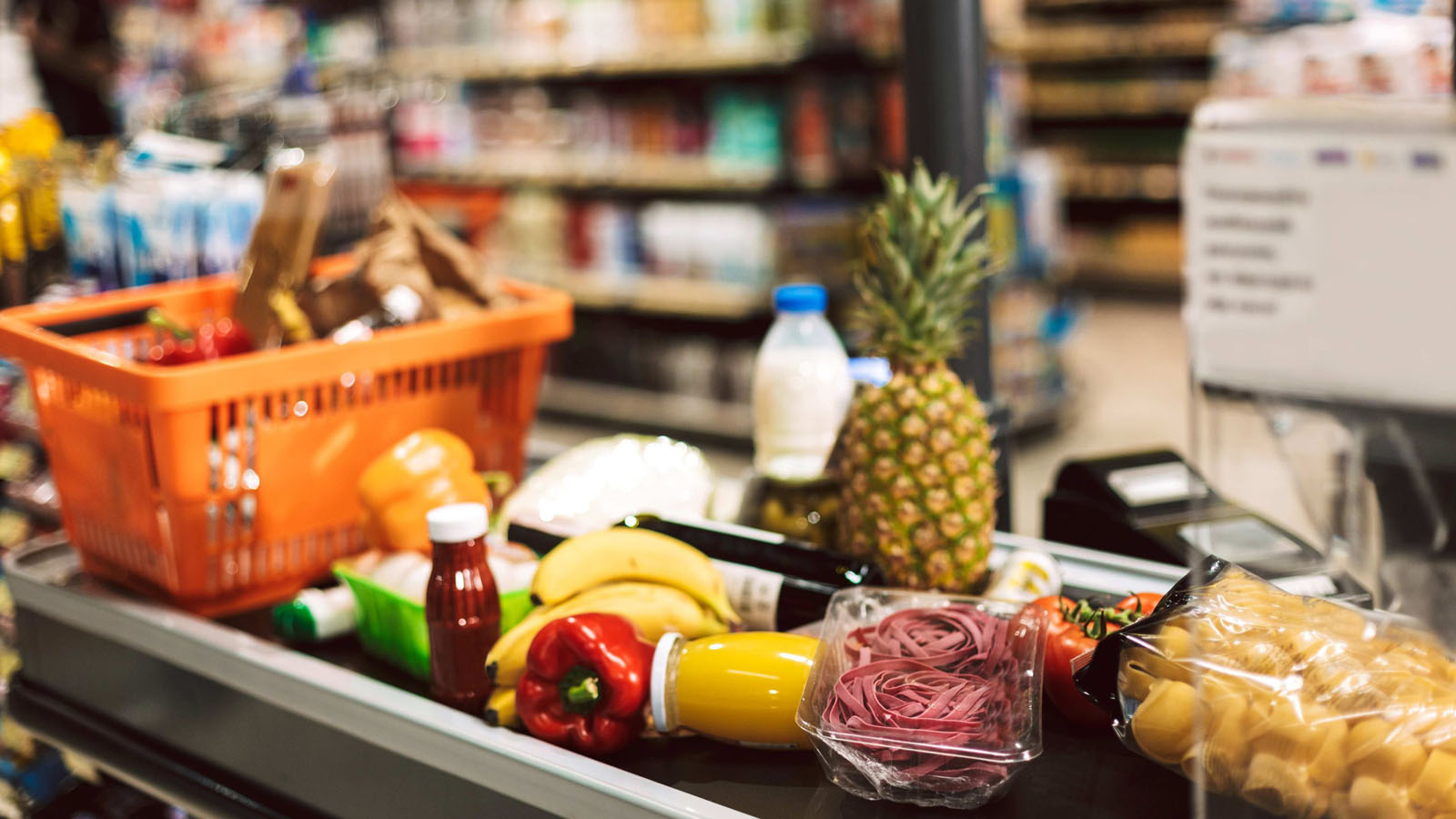 Shopping basket of fresh groceries at a checkout counter