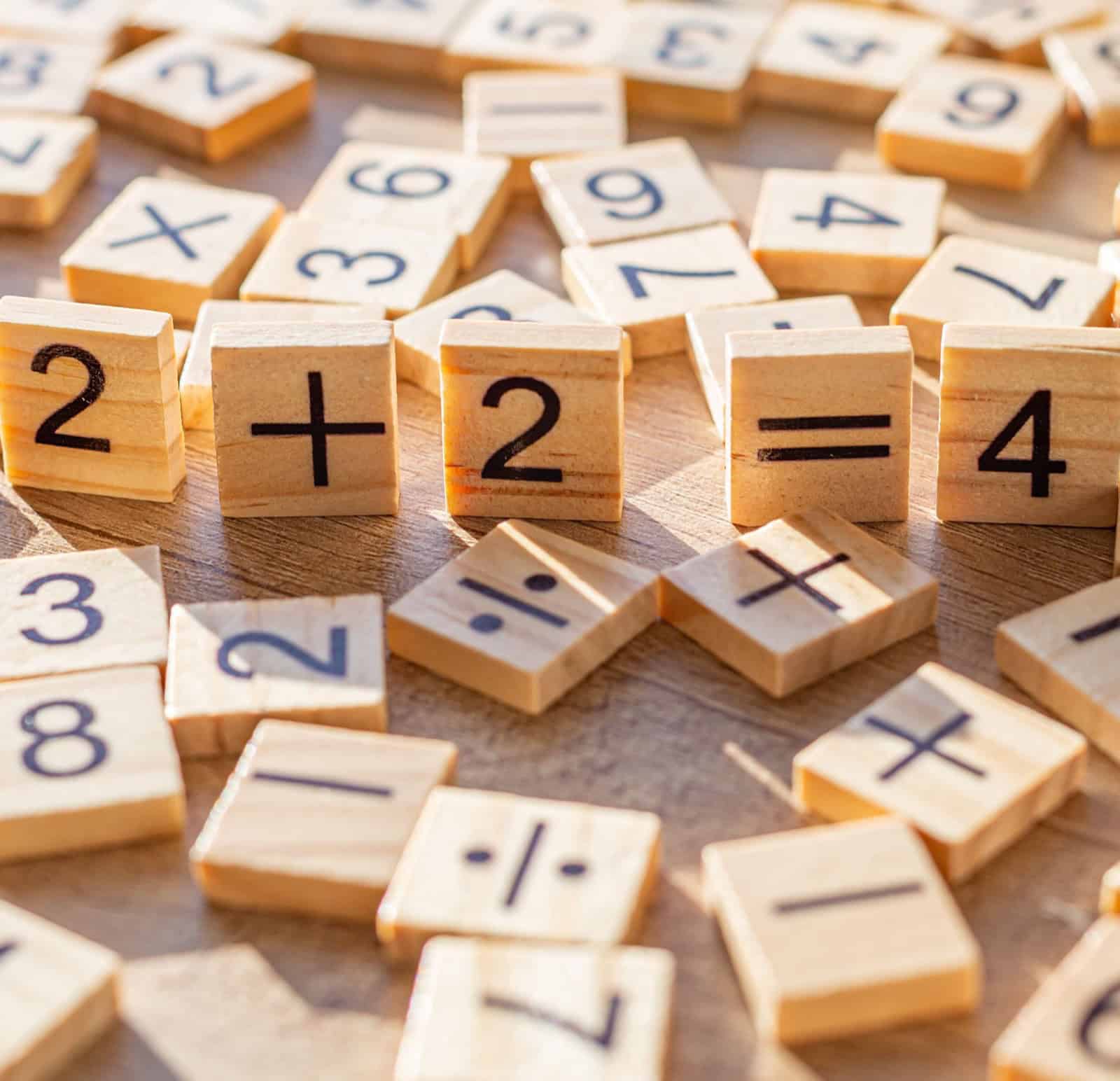 Letter tiles arranged as an equation