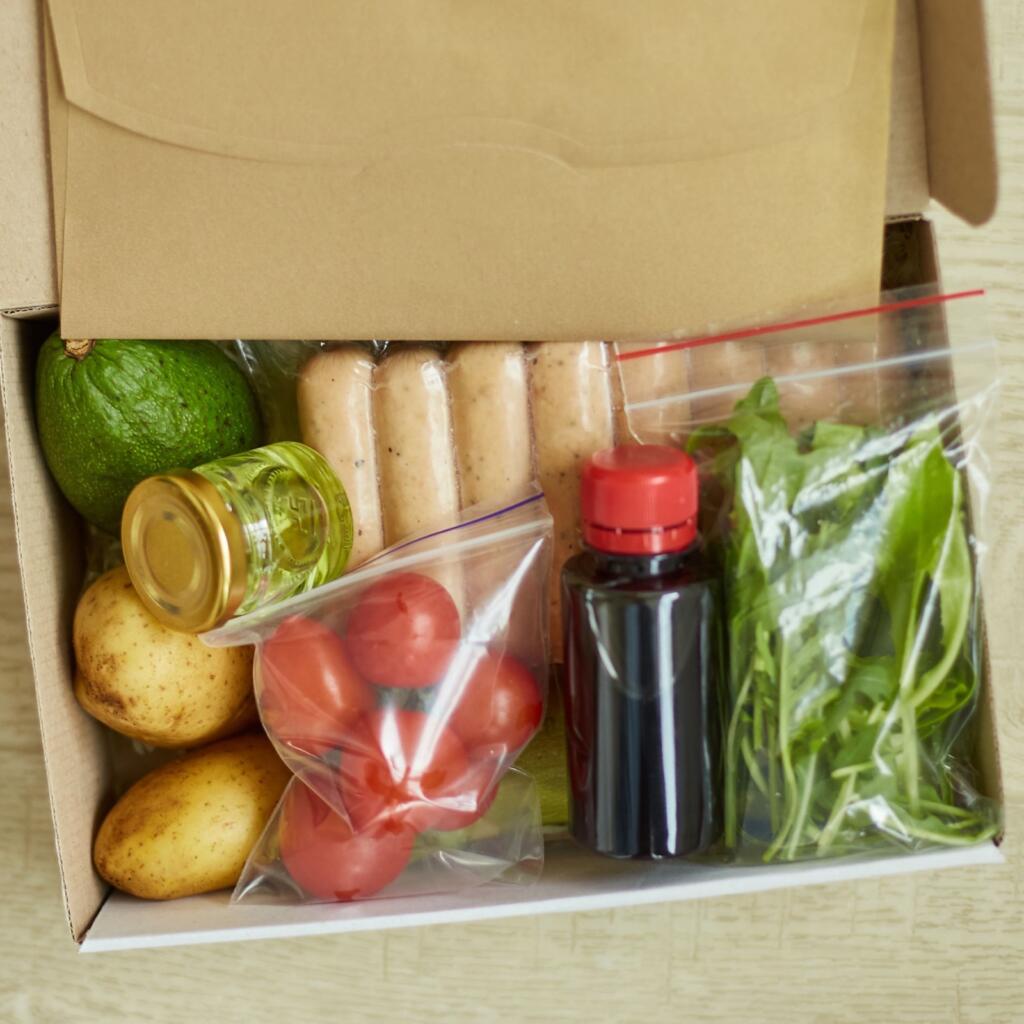 Meal kit box with packaged ingredients